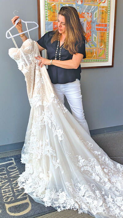  Owner Marie Selenica shows a designer  wedding gown for cleaning and preservation 