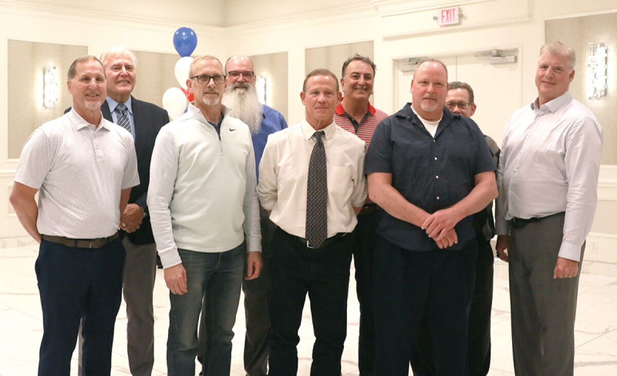  Players from the 1975-1978 Lake Shore High School varsity football team smile as the group gets inducted into the St. Clair Shores Athletic Hall of Fame. 