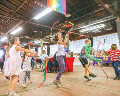  Kids dance to the music of Voxanna using rainbow ribbon. The city handed out twirlers, sunglasses, crowns and fans to children. 