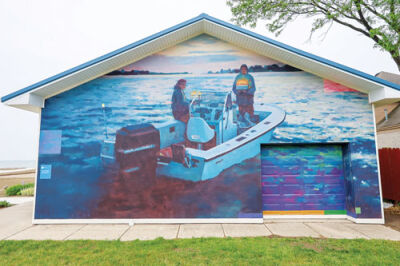  Harrison Township’s new mural depicts two men on a boat holding birthday cakes.  