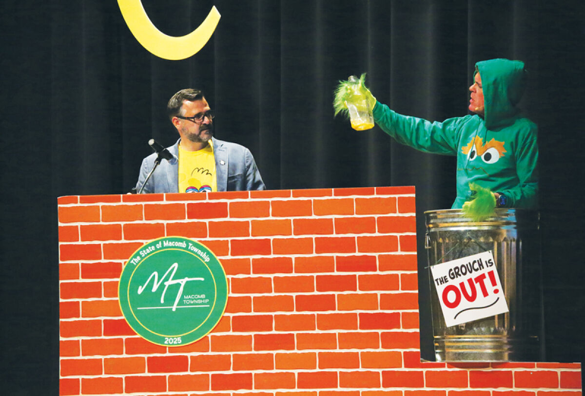  Macomb Township Supervisor Frank Viviano looks on bemused as Macomb County Executive Mark Hackel reviews the contents of Oscar the Grouch’s trash can at the 2025 State of Macomb Township address on June 13. Skits like this one divided sections of the address themed after the TV show “Sesame Street.” 