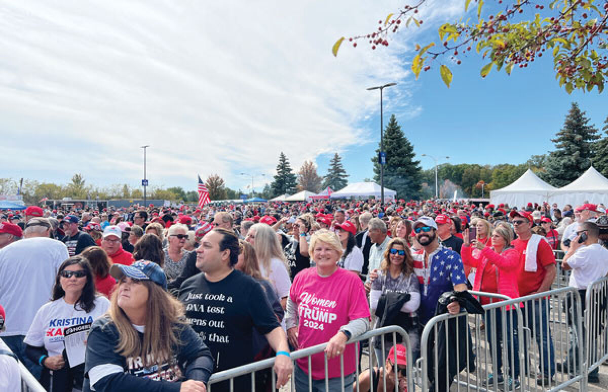  Supporters of former President Donald Trump wait in line Oct. 1 for his “Save America” rally at the South Campus of Macomb Community College in Warren. 