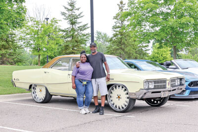  Director of Life Enrichment Monique Furness and her cousin, Andre Davis, of Detroit, pause for a picture with his 1968 Buick LeSabre. 