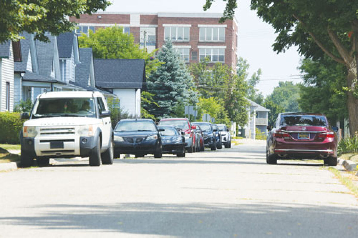  Parked cars line the sides of Beyne Street during the workday. Workers at the nearby post office park in the neighborhood, which has caused much discontent from residents. City commissioners approved a parking zone ordinance that aims to curtail the issue. 