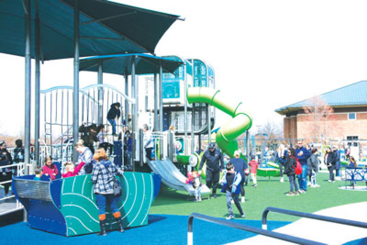  Kids and adults visit the Clinton Township inclusive playground on the day of its April 4 ribbon-cutting. The Clinton Township Board of Trustees voted to dissolve the committee that formed the playground at the board’s July 14 meeting.  