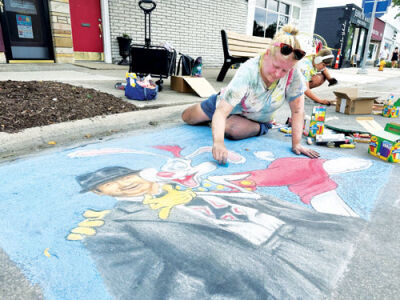  Hilary MacDonald puts the finishing touches on her “Who Framed Roger Rabbit” chalk art at the Berkley Street Art Fest. 