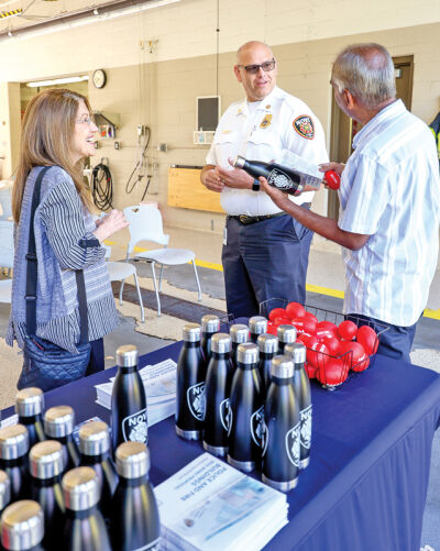  Novi Assistant Fire Chief Todd Seog discusses the bond proposal  with residents during an open house June 14 at Fire Station No. 2. 