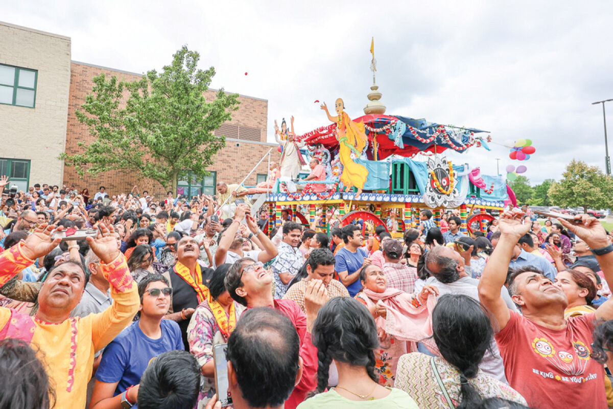  Festivalgoers surround a chariot that carries the Hindu gods Lord Jagannath, Balarama and Subhadra as it arrives at Fuerst Park near Novi High School July 20. 