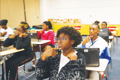  Lincoln Middle School student Isaiah Edwards learns how to sign “No, I am deaf” in sign language.  