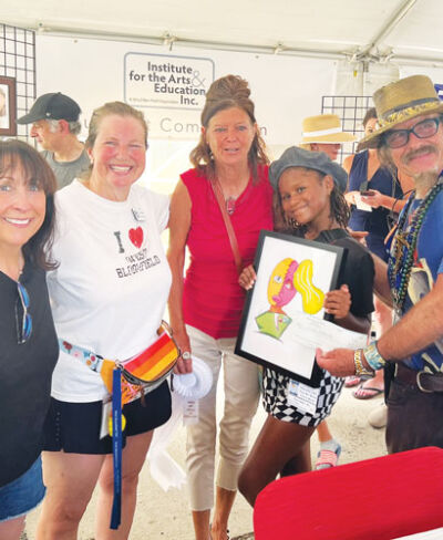  Olori Amen-Ra, 8, second from right, submitted a painting described as “Picasso-esque” by panel judge John Crutchfield, right. Joining Amen-Ra are Debbie Binder and Teri Weingarden, both members of the West Bloomfield Board of Trustees.  