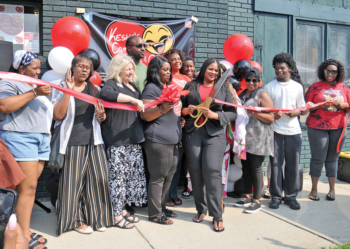  A ribbon cutting and grand opening for Kesha’s Comedy House and Grille was held July 31. Comedian Kesh Gallman, pictured with scissors, looks forward to bringing talented comics to Eastpointe. 