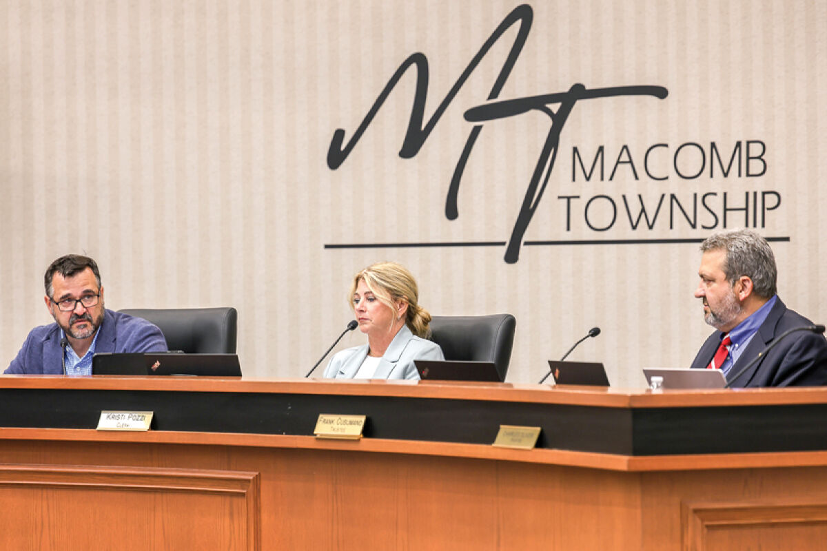  Township Supervisor Frank Viviano, Township Clerk Kristi Pozzi and Trustee Frank Cusumano go over business at the July 23 Macomb Township Board of Trustees meeting. 