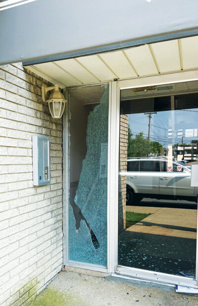  A window of the apartment building was damaged from gunshots near where the victim was found. 
