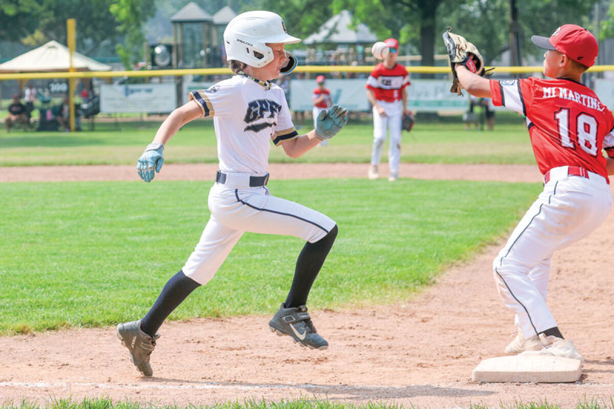  Grosse Pointe Farms-City’s Wesley Marchal beats out an infield single in the championship game against Greater Bay Little League. 