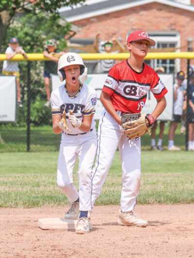  Grosse Pointe Farms-City player Jack Mulvaney celebrates on second  base after hitting a double. 