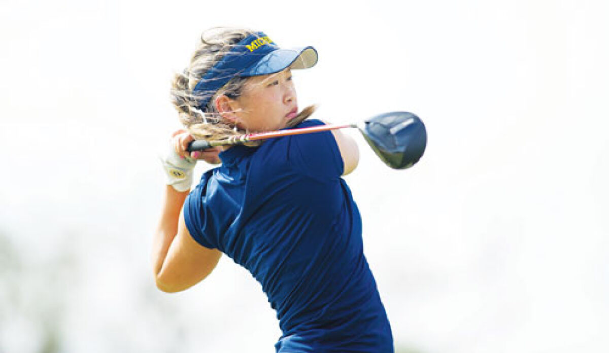  Grace Wang stares down a drive earlier this season for the University of Michigan’s women’s golf team. 