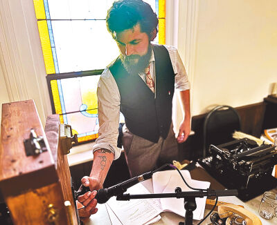  Alex Konieczny, the youth programs director for Troy Historic Village, creates live sound effects. 