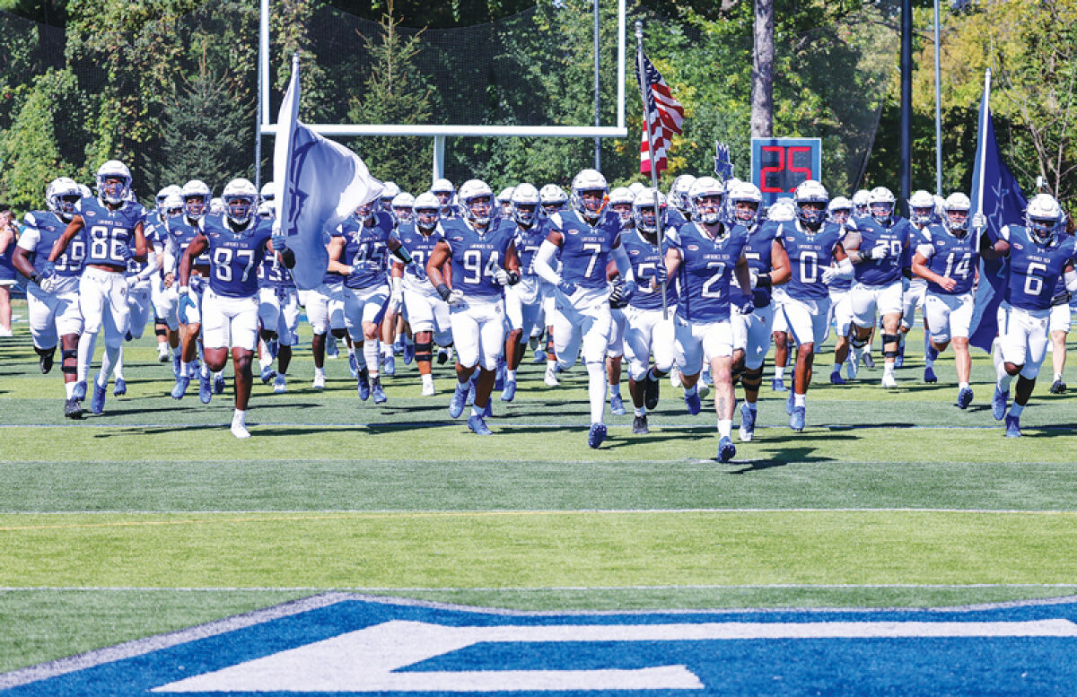  The Lawrence Tech football team runs onto the field before kickoff last season. 