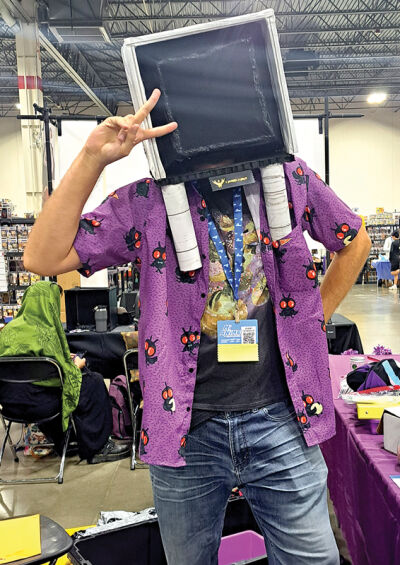  Oliver W. Decay shows off his Twitch/Purple Mage Publishing persona “CozyTv” during the MiAnime Convention on Aug. 3. 