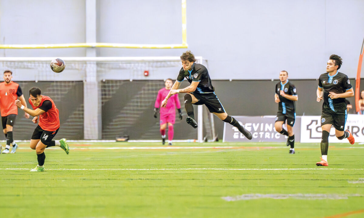  Tattoo artist and DMFC striker Max Rugova Jr. kicks a ball downfield. 