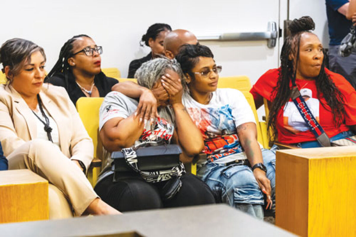  Relatives of Cedric Hayden Jr. and DeJuan Pettis, who were both killed when former Warren police officer James Burke hit the vehicle they were traveling in, comfort each other as the judge delivers his ruling at the conclusion of Burke’s exam hearing on Aug. 15.  