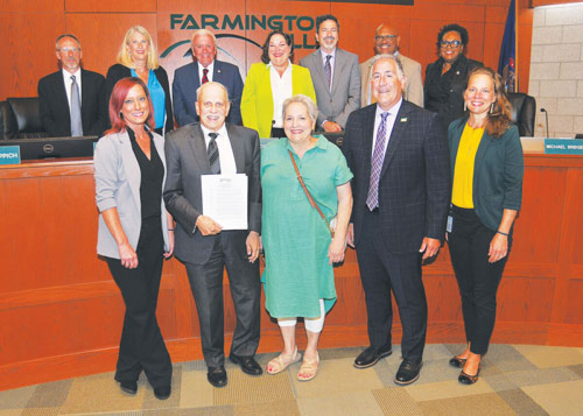  At the Farmington Hills City Council meeting Aug. 11, Jim Cubera and his wife Mary K., center front row, celebrate the proclamation he received for 48 years of service as a city engineer. 