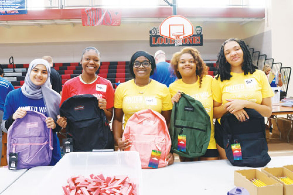  Lincoln High School students, from left to right, Sadya Hashem, Kyla Jordan, Deja Coachman, Rajae Noble and Ranae Noble help fill backpacks with school supplies.  