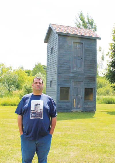 Krasnik had a T-shirt made of the two-story outhouse in Cedar Lake.