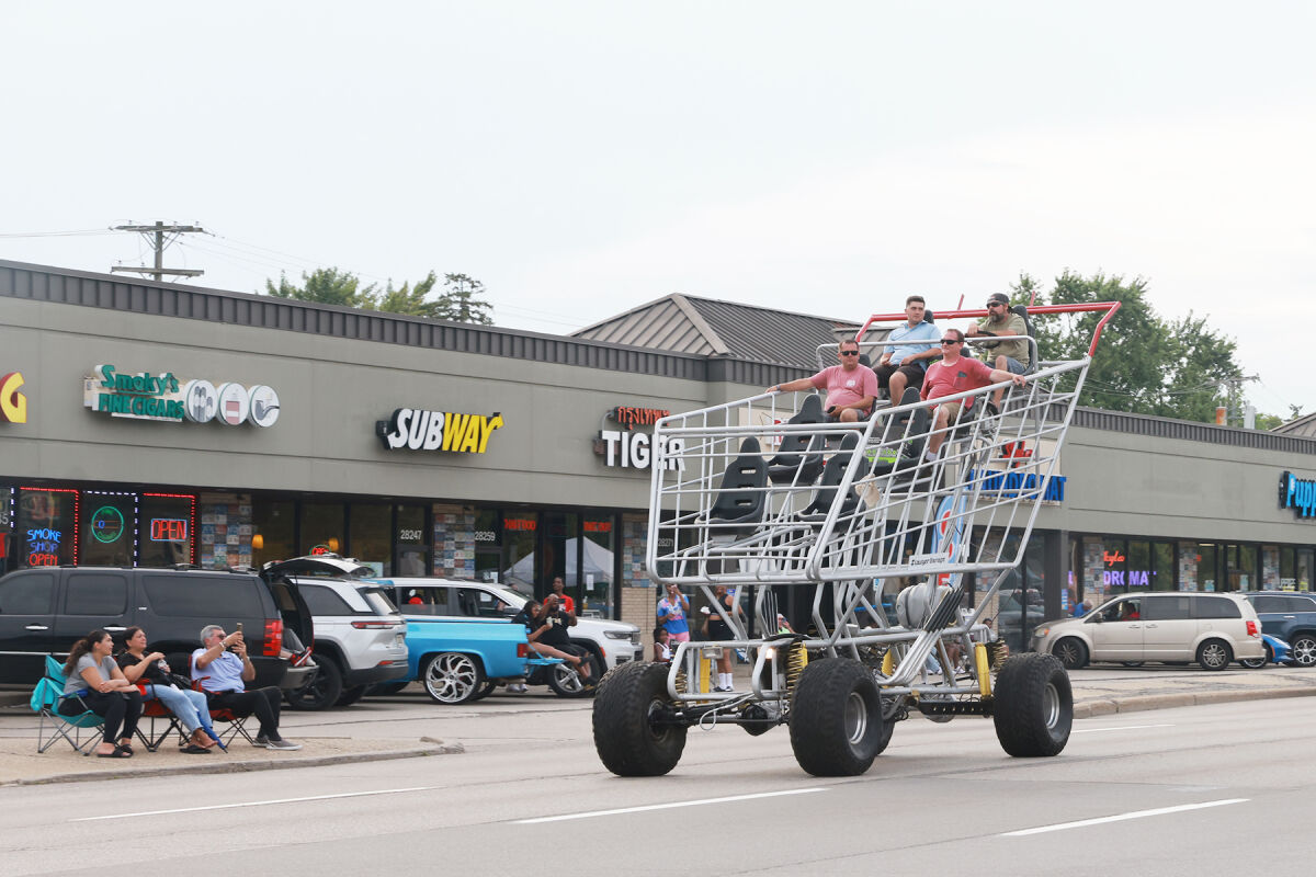  A giant shopping cart drives down Woodward Avenue in Royal Oak during the Dream Cruise.  