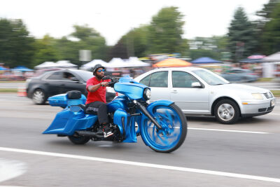 A motorcyclist rides on Woodward Avenue during the Woodward Dream Cruise.