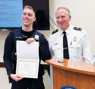  From left, Grosse Pointe City Public Safety officer Jacob Gentile receives his Officer of the Year award from Public Safety Director John Alcorn. 