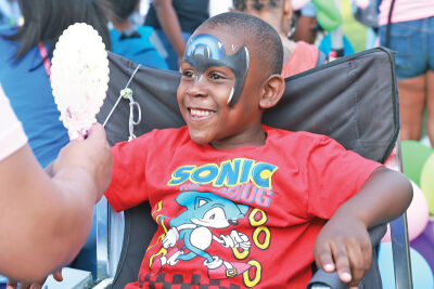  Reginald Culbertson III, 5, of Southfield, smiles as he sees his Batman face paint. 