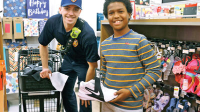  Novi police, firefighters take youth school shopping 