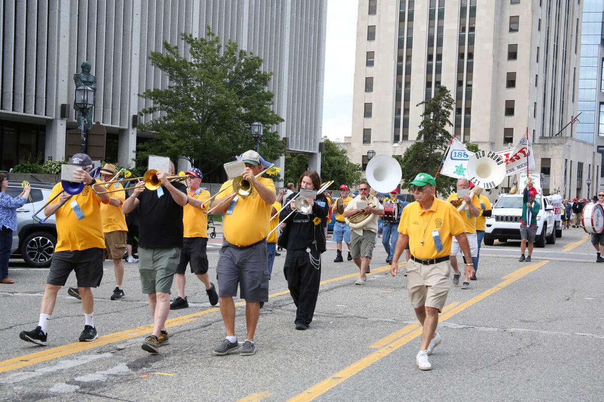  Members of the Old Crowd marching band lead the Old Crowd parade down Main Street in Mount Clemens on Aug. 21. 