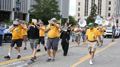  Members of the Old Crowd marching band lead the Old Crowd parade down Main Street in Mount Clemens on Aug. 21. 