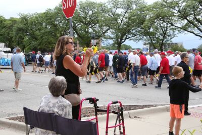  Onlookers watch as the Old Crowd parade makes its way down Main Street in Mount Clemens en route to the Clinton River on Aug. 21. 