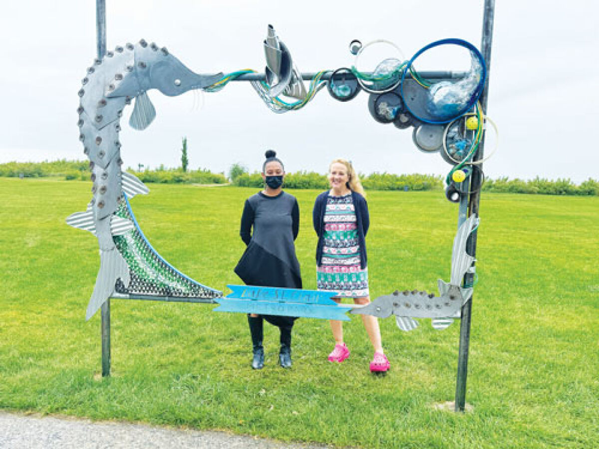  Artist Halima Afi Cassells and Huron-Clinton Metroparks CEO Amy McMillan pose with the  new art installation at Lake St. Clair Metropark in Harrison Township.  