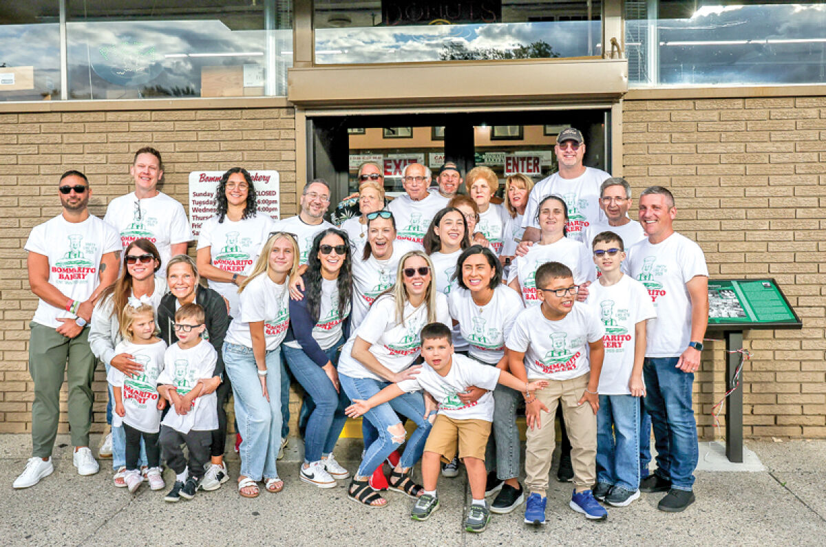  The Bommarito family stands for a photograph in front of the Jim Bommarito Bakery storefront on Greater Mack. 