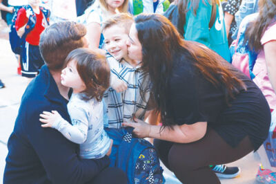  Uarda Vrame and her husband, Ilir Vrame, from Shelby Township, give their son Liam Vrame a kiss goodbye on his first day of kindergarten at Morgan Elementary School. 