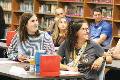  Kment Elementary School fourth grade teacher MacKenzie Cusimano, left, and building data coach Melissa Tompkins, right, participate in the new teacher and support staff orientation in Roseville Community Schools Aug. 25. 