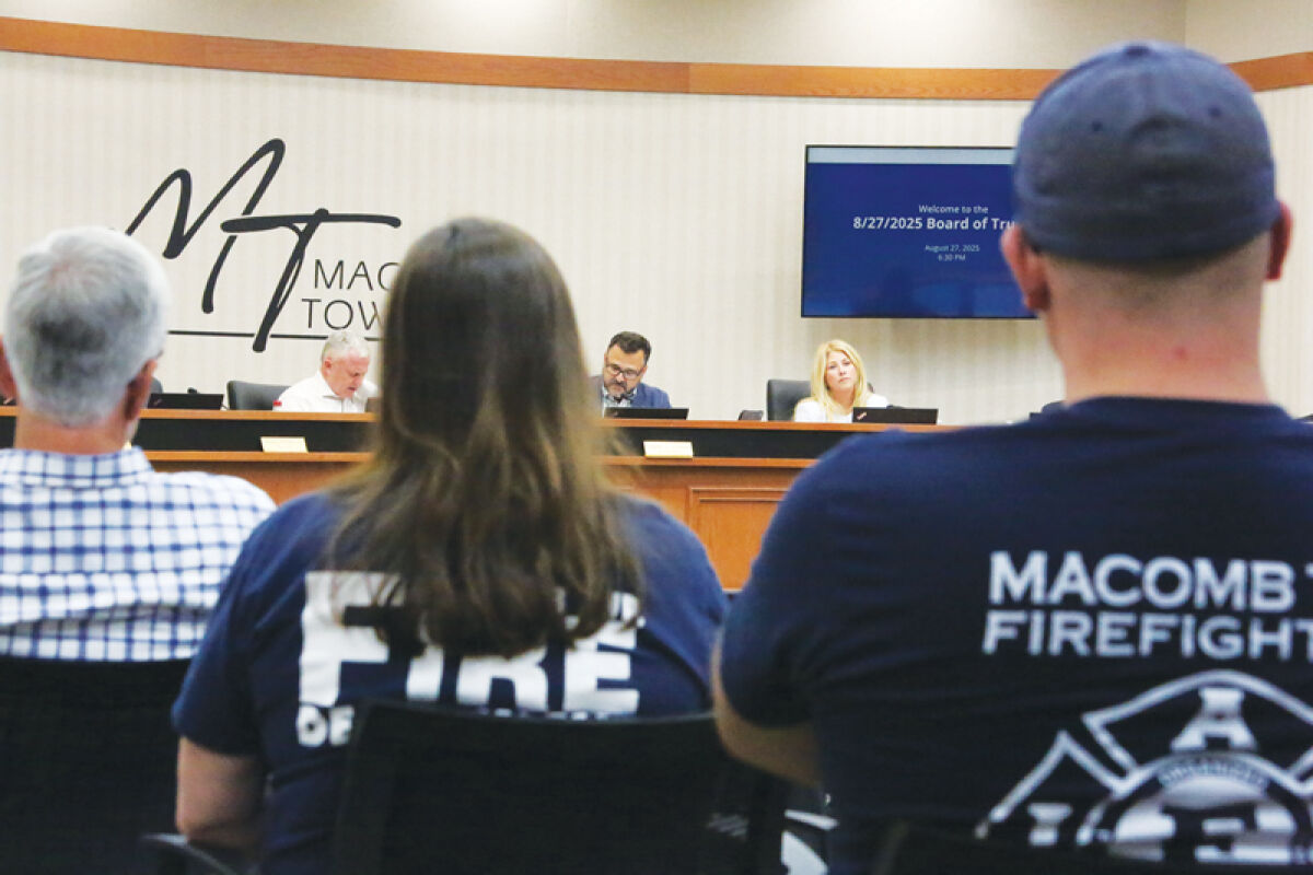  Macomb Township firefighters and supporters watch Township Treasurer Leon Drolet, Supervisor Frank Viviano and Clerk Kristi Pozzi at the Aug. 27 Board of Trustees meeting. Trustees approved posting seven full-time fire department positions and instituting hiring incentives for part-time firefighters. 