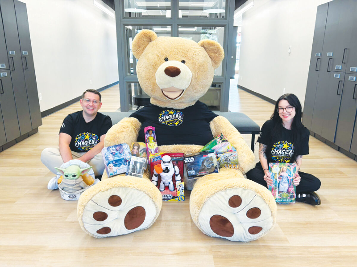  Nick Parrino and Nicolette Derespino, from Cornerstone Community Financial Credit Union, pose with Freddy the Teddy. 