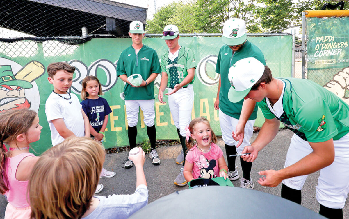  Leprechauns players sign autographs for kids during Strike Out Cancer Night on July 2. 