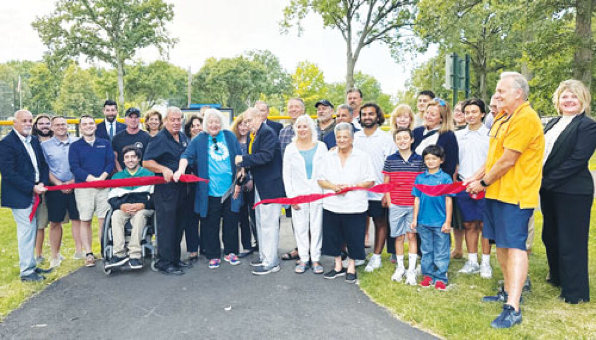  Grosse Pointe Woods officials, donors and supporters of a new walking path and benches at Ghesquiere Park gather for a ribbon cutting to officially mark the path’s opening Aug. 26. 