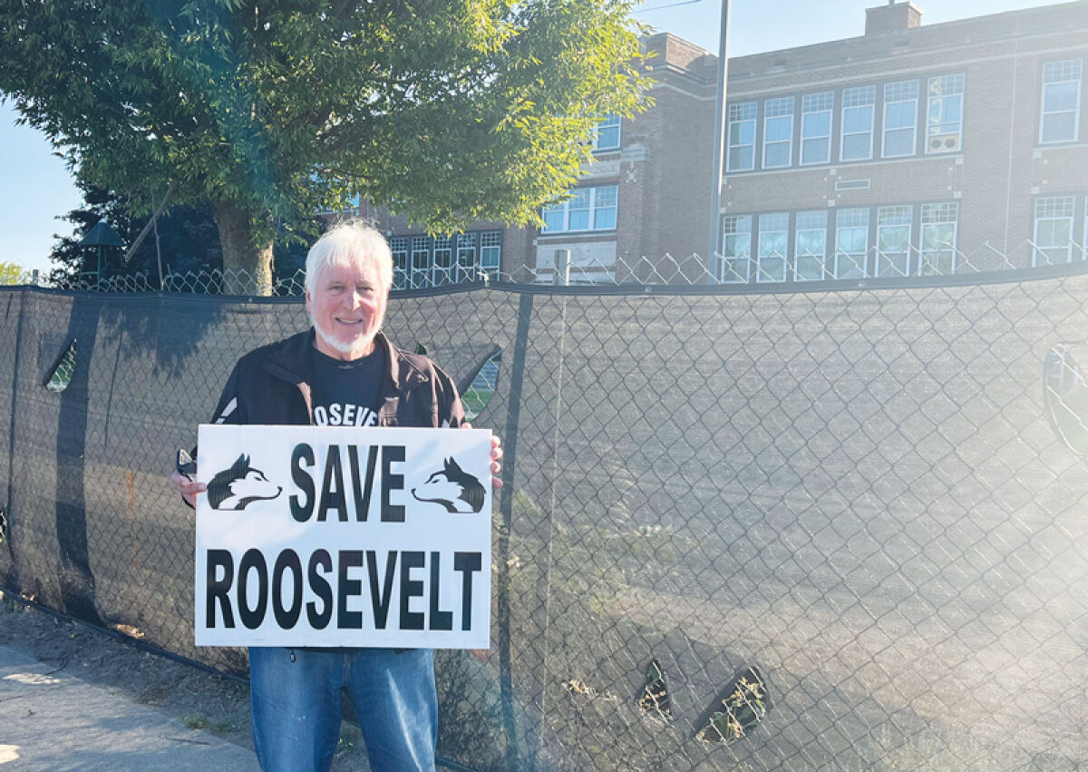  Christian Sonneville stands in front of Roosevelt Elementary, in Keego Harbor, protesting its demolition as crews begin asbestos abatement. 