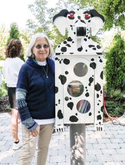  Julie Dreyer, Andrews’ daughter, with the outdoor library. 
