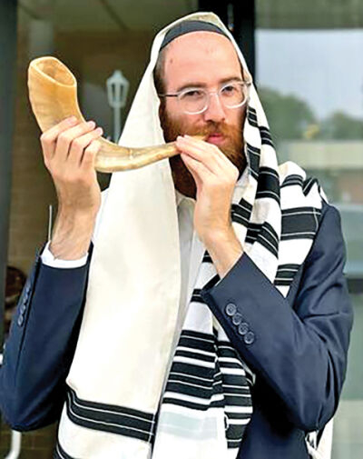  Rabbi Moishie Glitsenstein blows the shofar. 