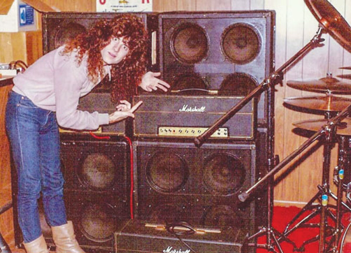  With a stack of Marshall amps, Jimmy Burkard’s first band, Atomic Axe, practiced regularly  in his parents’ basement in  Warren back in the 1980s. 