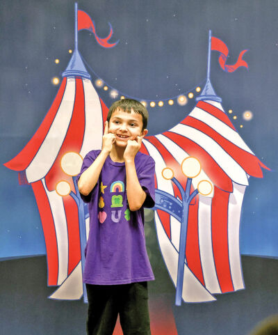  Third grader Rowan Mathur checks out the big top backdrop. 