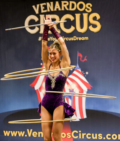  Aerialist and contortionist Sno Bunta wows the crowd with her hula-hoop routine. 